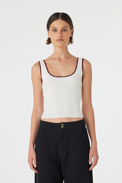Model wearing Kaya Tank in cream with merlot contrast trim, slim-fit organic cotton knit tank, front close view.