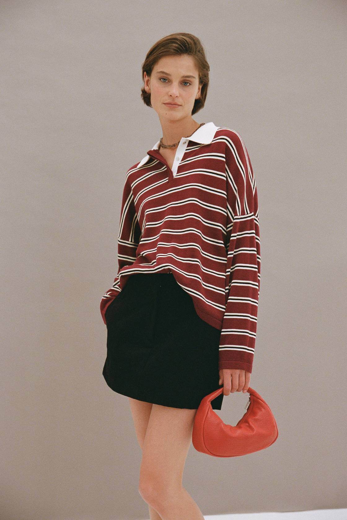 Rayne Knit Jersey merlot stripe styled with mini skirt, oversized polo knit with contrast collar and dropped shoulder, outfit view.