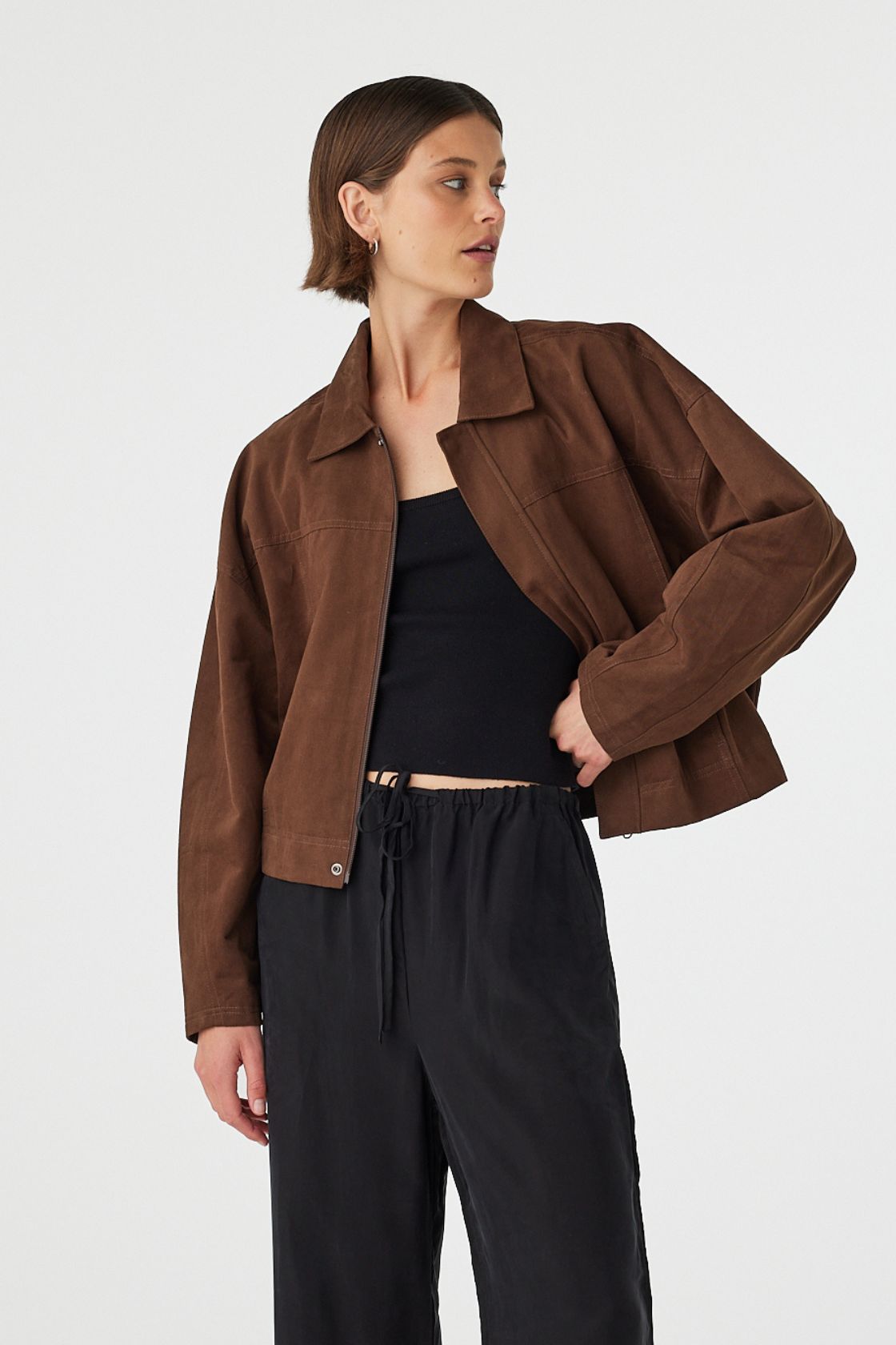 Eames jacket in espresso worn at an angle open, showcasing the soft cotton finish, structured collar and cropped silhouette