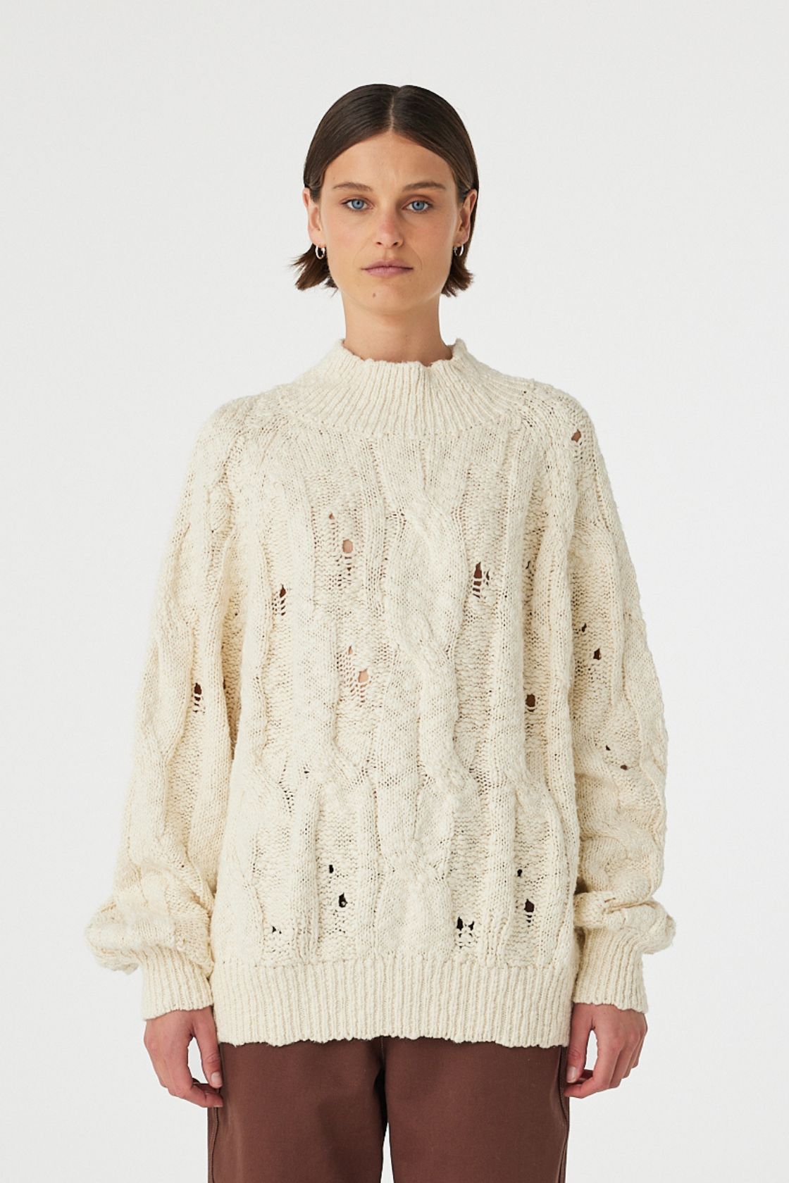 Front view of cream sweater showing relaxed oversized fit