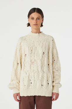 Front view of cream sweater showing relaxed oversized fit