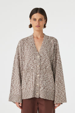 Emmet cardigan in chocolate and cream worn front on, showcasing the longline relaxed fit, textured slub knit and centre front button closure, styled with matching knit pants 
