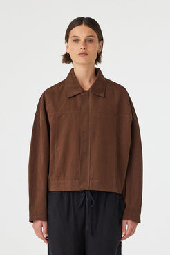 Eames jacket in espresso worn front on, showcasing the cropped boxy fit, clean front panel and concealed zipper, styled with black wide-leg pants