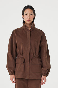 Amari Jacket in espresso with a soft velvet finish, styled with matching straight-leg pants, featuring oversized flap pockets and a high funnel neckline