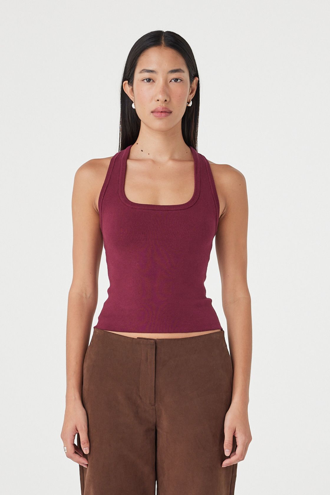 Full-length front view of the Sable Top in merlot styled with espresso straight-leg pants, featuring a clean scoop neckline and minimal slim fit