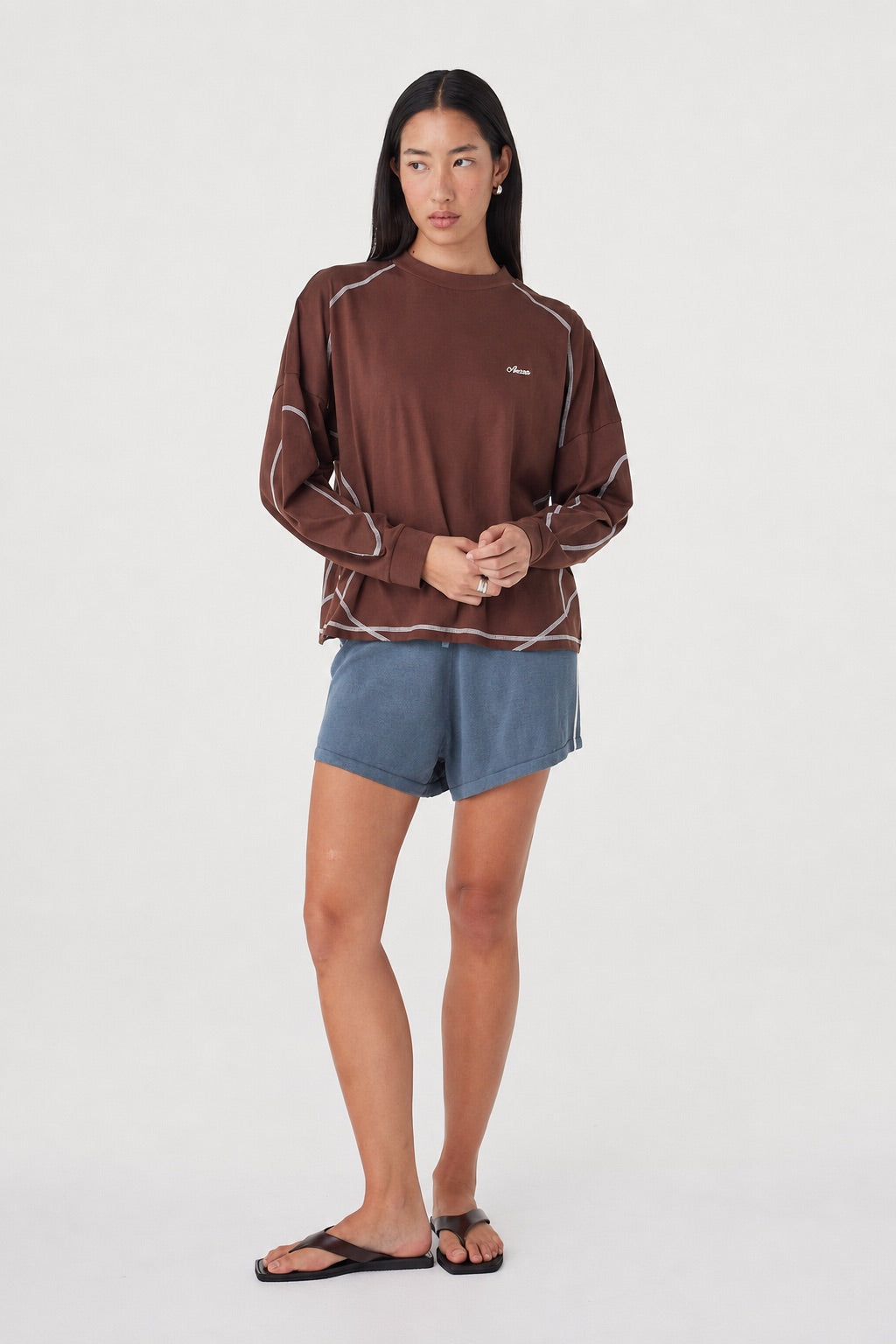 Full-length front view of the Kesh LS Tee in Espresso & Cream showcasing the relaxed fit, long sleeves and contrast stitching, paired with blue lounge shorts.
