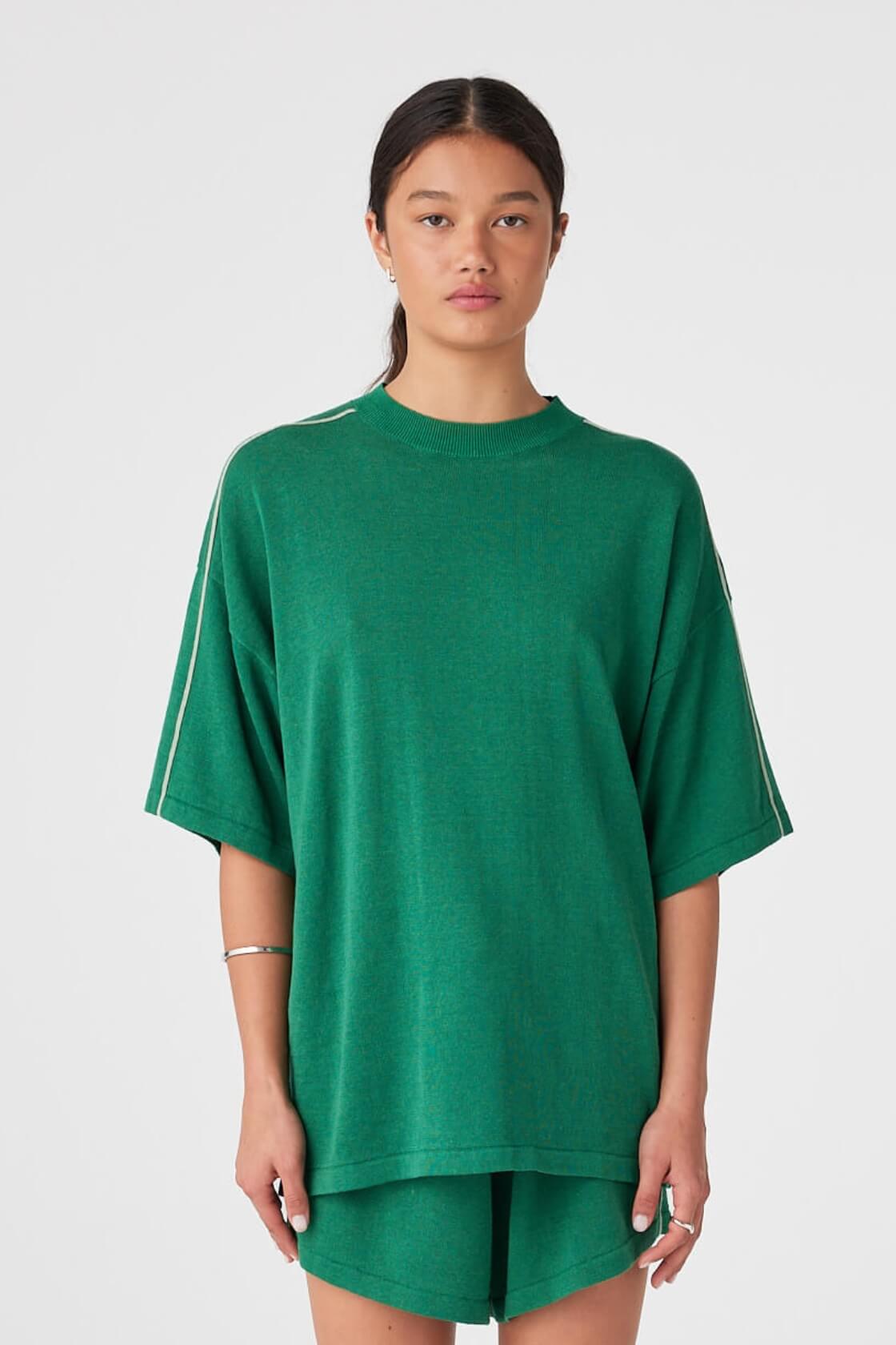 Model wearing oversized sea green linen–cotton tee with drop shoulders and contrast stripe detailing.