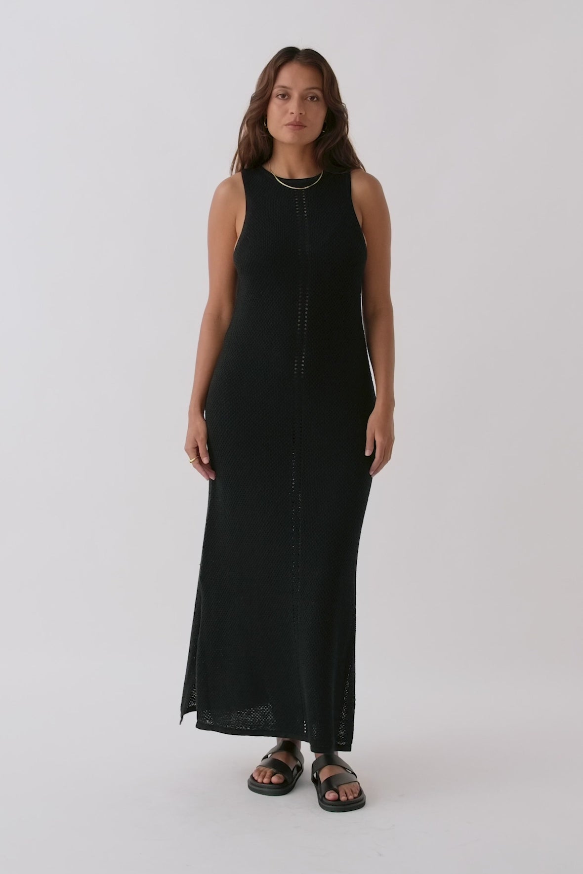 Video of Sloane Dress in black, highlighting high neck, A-line fit, and open knit detail at the centre front, crafted from sustainable organic cotton-linen blend.