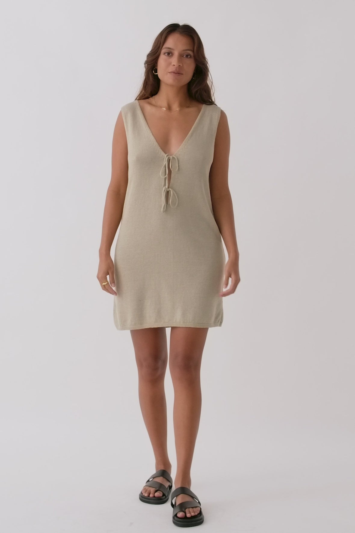 Video of Poppy Mini Dress in taupe, highlighting V-neck, tie accents, and lightweight organic cotton-linen construction for sustainable fashion